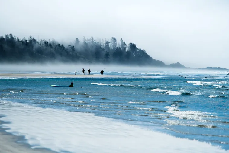 Surfer riding a wave on Vancouver Island