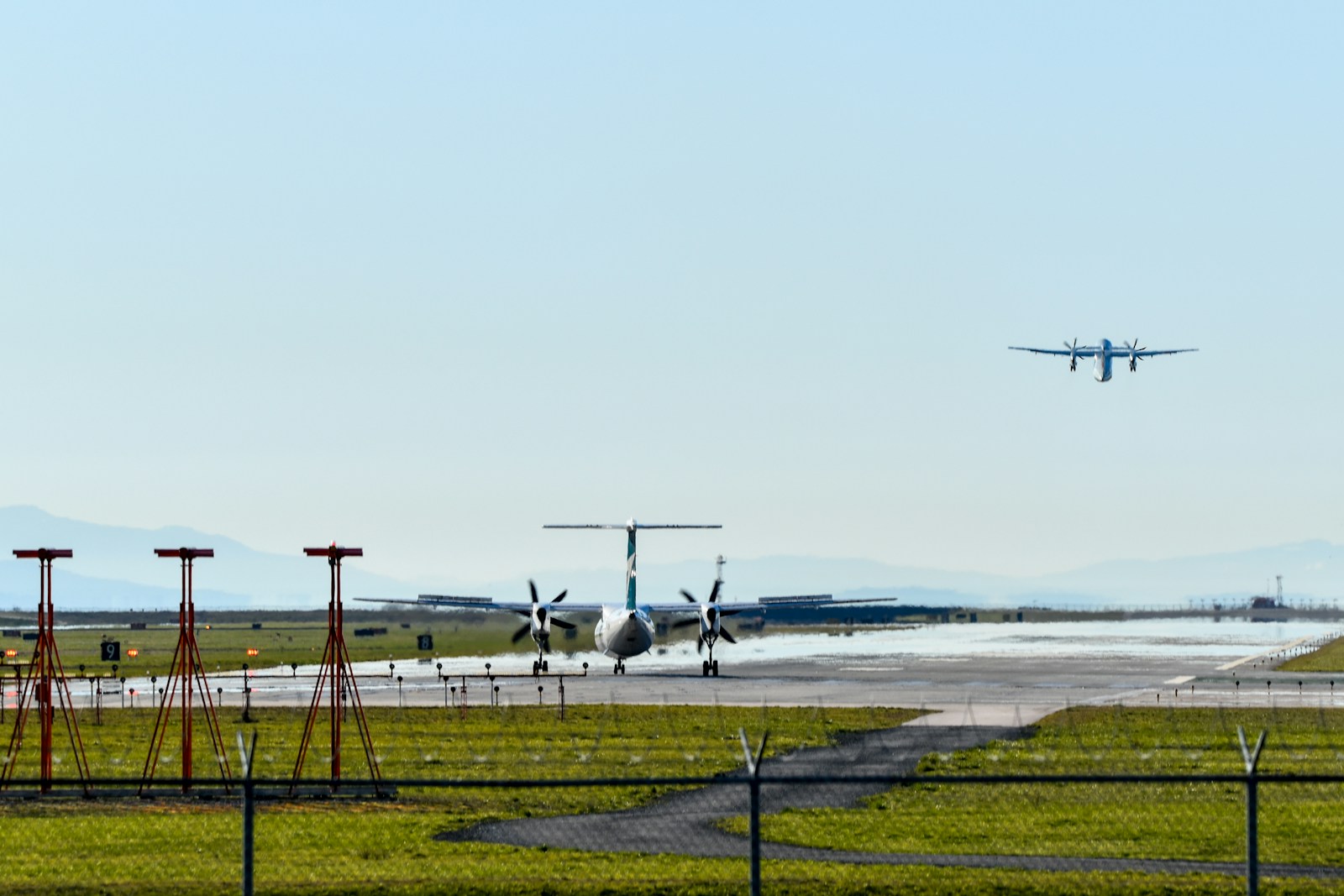 An aircraft on approach over the runway at Vancouver International Airport