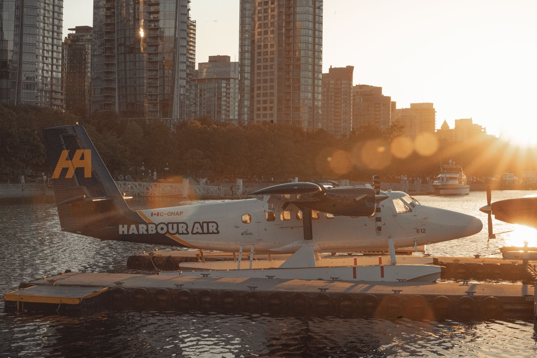 A seaplane at the Coal Harbour dock below the downtown Vancouver towers