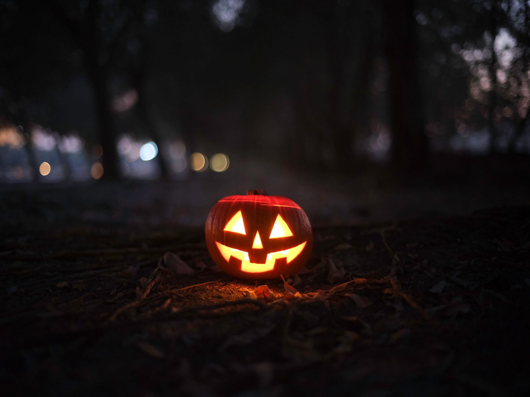 A carved jack-o'-lantern glowing in the dark