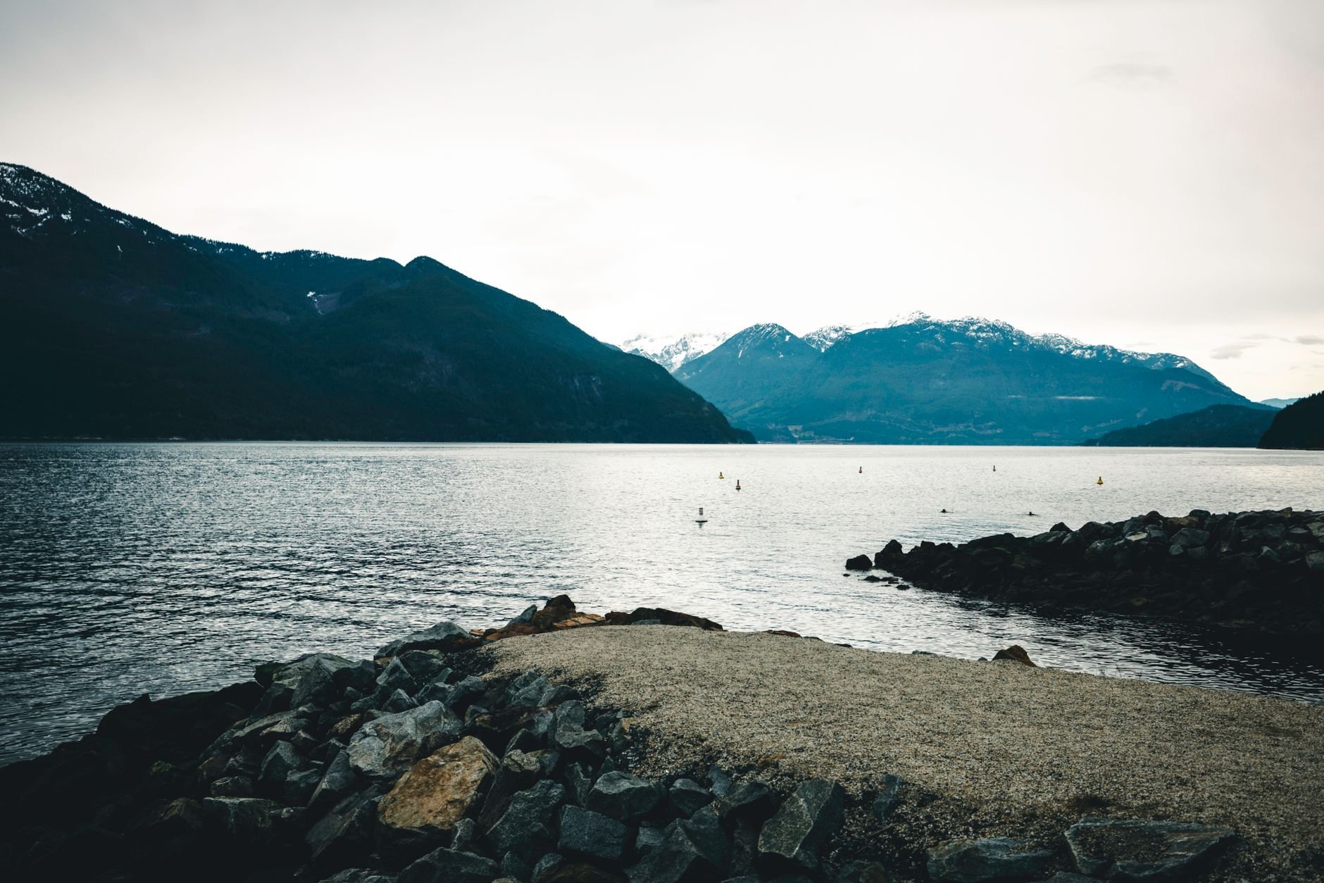 Mountains across Howe Sound, seen from a rocky shoreline