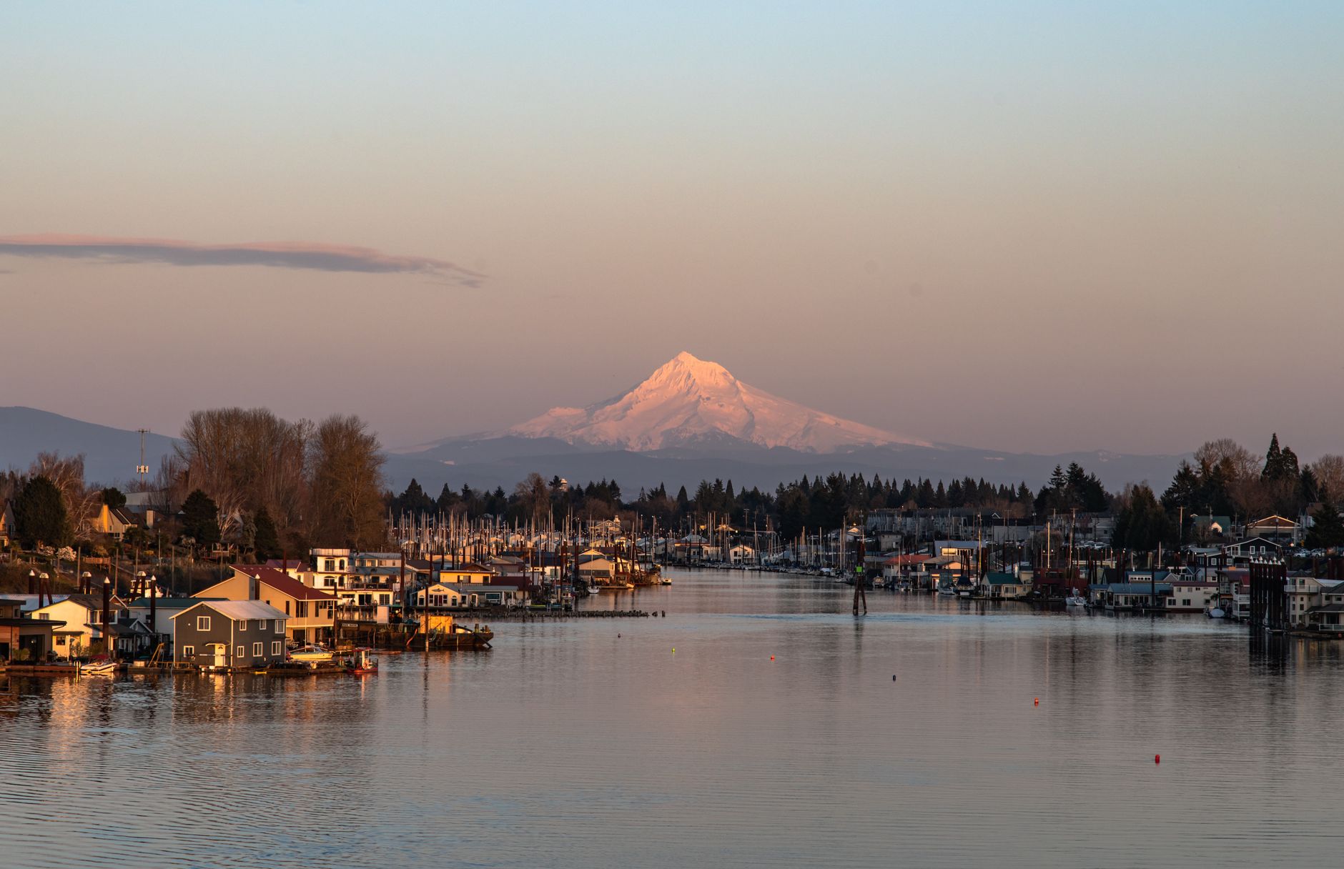 Portland Oregon skyline with Mount Hood at sunset over the Willamette River